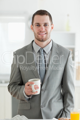 Portrait of a businessman having breakfast