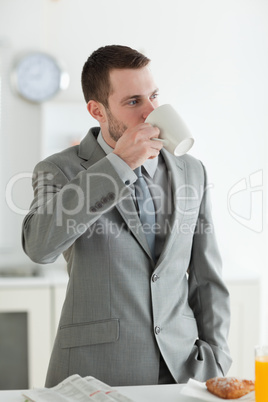 Portrait of a good looking businessman having breakfast