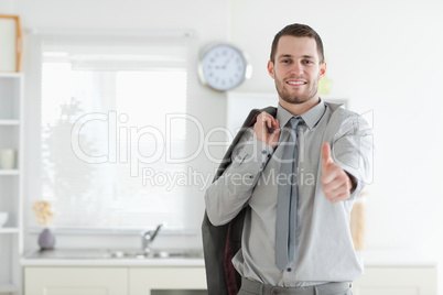 Businessman posing with the thumb up