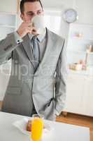 Portrait of an attractive businessman having breakfast