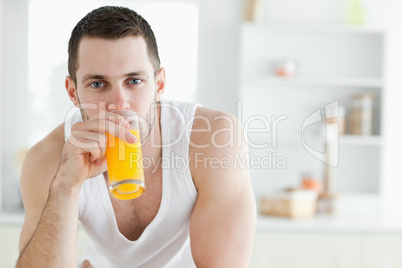 Good looking man drinking orange juice