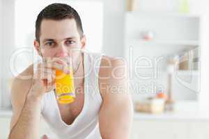 Good looking man drinking orange juice