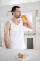 Portrait of a healthy man drinking orange juice