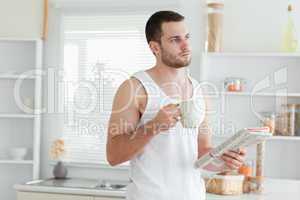 Dreaming man drinking coffee while reading the news