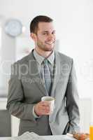 Portrait of a smiling businessman having breakfast