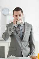 Portrait of a handsome businessman having breakfast