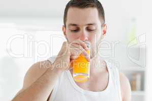Attractive man drinking orange juice