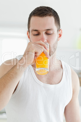 Portrait of an attractive man drinking orange juice