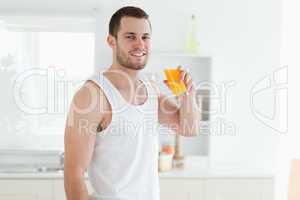 Smiling man drinking orange juice