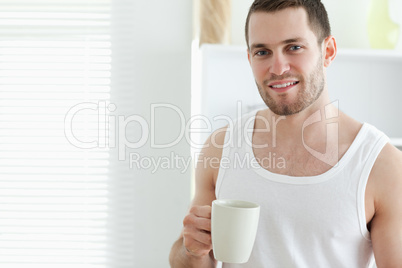 Smiling man drinking coffee