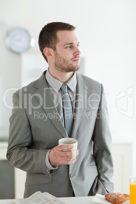 Portrait of a young businessman having breakfast