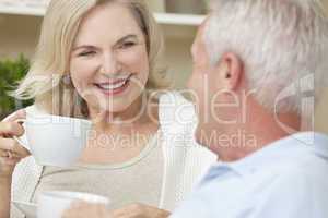 Happy Senior Man & Woman Couple Drinking Tea or Coffee