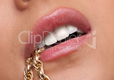 Beauty woman lips desired with gold chain