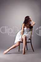 Perfect dancer in white cloth sit on chair