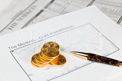 Golden Eagle coins on newspaper