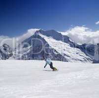 Snowboarder in high mountains