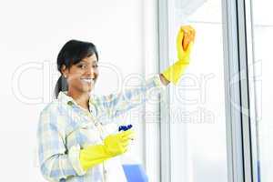 Smiling woman cleaning windows