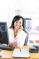 Smiling black businesswoman at desk