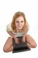 Girl with laptop on floor.
