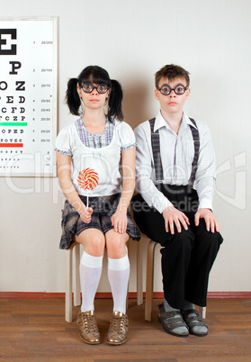 Two person wearing spectacles in an office at the doctor