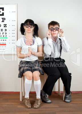 Two person wearing spectacles in an office at the doctor