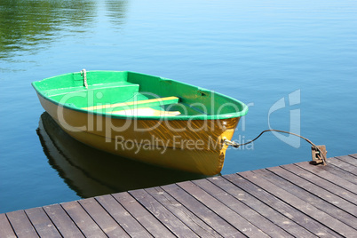 A small boat parking at a wood dock