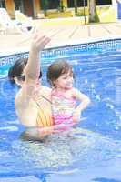 Mother and baby playing in a swimming pool