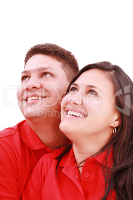 Young loving couple looking up to the sky, standing over white,