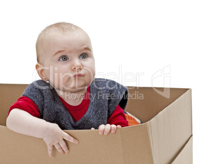 young child in cardboard box