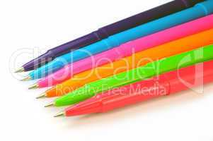 Multicolor pens on white background.