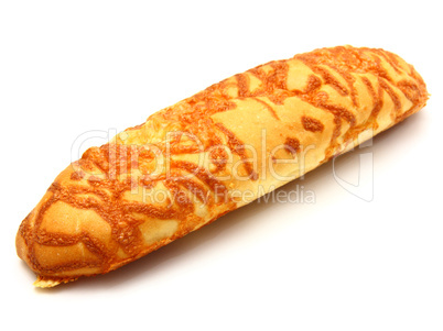 The ruddy long loaf of bread is strewed by cheese