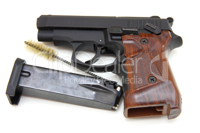 The close up of a pistol a target and cartridges is isolated on