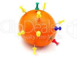 Isolated colourful office pins thrust in an orange