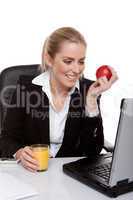 woman eating apple and drinking orange juice