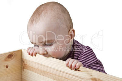 baby looking into wooden box