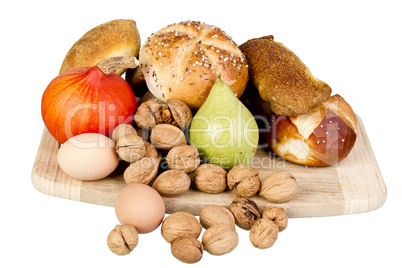gem, nuts, eggs and a pine on a wooden board