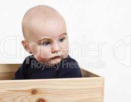 toddler in wooden box