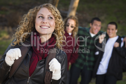 Pretty Young Teen Girl with Boys Behind Admiring Her