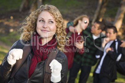 Pretty Young Teen Girl with Boys Behind Admiring Her