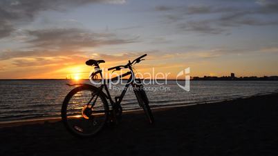 Bicycle on the coast at sunset