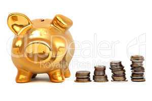 golden piggy bank and stacks of coins