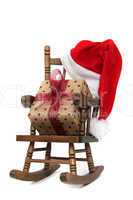 old wooden rocking Chair with red jelly bag cap and christmas present
