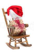 old wooden rocking Chair with red jelly bag cap and christmas present