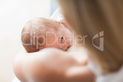 Above view of newborn getting breastfed
