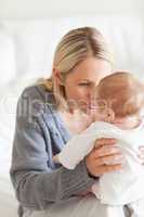 Affectionate mother with baby on her lap