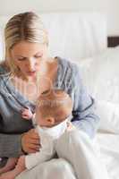 Affectionate mother with newborn on her lap