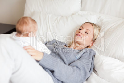 Mother lying in the bed with her baby