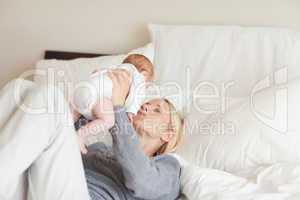 Young mother playing with her newborn