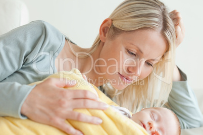 Mom relaxing next to her sleeping baby