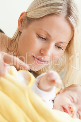 Close up of mother relaxing next to her sleeping baby